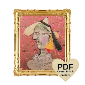 May include: A framed artwork featuring a Picasso-style portrait with a hat. The portrait has a pink, yellow, and black color scheme. The frame is gold with ornate detailing. A heart-shaped graphic with the text "PDF Cross Stitch Pattern" is in the lower right corner.