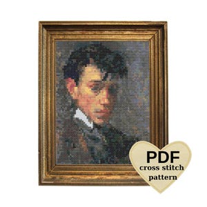 May include: Framed cross-stitch portrait of a man with dark hair and a white collar. The artwork is in a gold-colored frame. A heart-shaped tag with the text "PDF cross stitch pattern" is in the lower right corner.