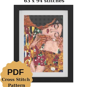 May include: Framed cross-stitch pattern of a couple embracing, inspired by Gustav Klimt's "The Kiss." The artwork features a black frame and a PDF cross-stitch pattern. The text "63 x 94 stitches" is at the top.