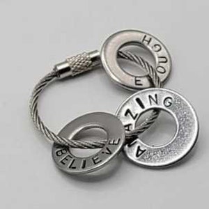 May include: Silver key chain with three round metal tags. The tags have the words "Believe", "Amazing", and "Enough" engraved on them.