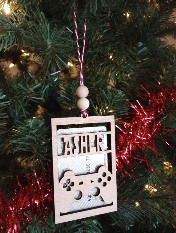 Laser-cut wooden gift card holder shaped like a gaming controller — a reusable, personalized ornament that makes a boring gift card feel like a real present.