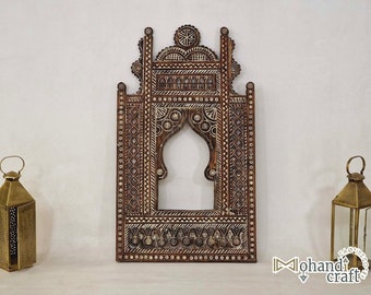 May include: A decorative wooden frame with intricate carvings and a white painted design. The frame has a traditional Moroccan style and is perfect for displaying photos or artwork.
