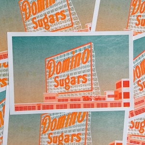 May include: Multiple prints featuring the Domino Sugars sign in orange and white against a teal and peach gradient background. The prints depict the sign and a factory building.