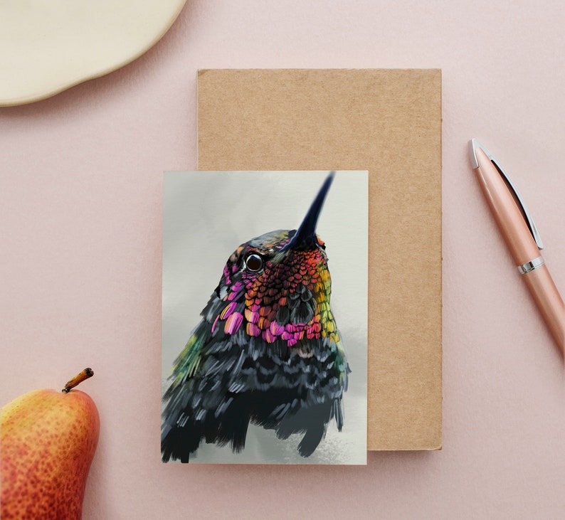 May include: A close-up of a hummingbird with iridescent green, blue, and pink feathers. The bird's head is tilted up, and its eye is visible.