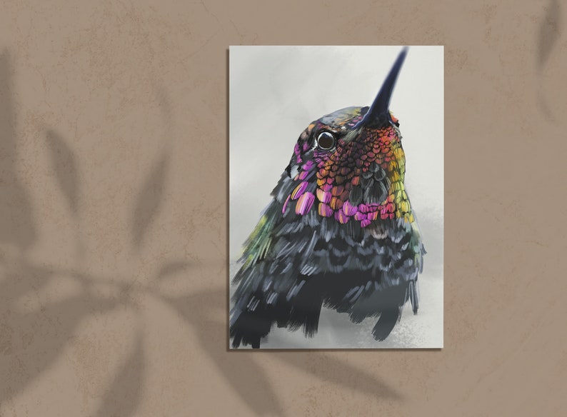 May include: A close-up of a hummingbird with iridescent green, pink, and orange feathers. The bird's head is tilted up, and its eye is visible. The background is a soft white.