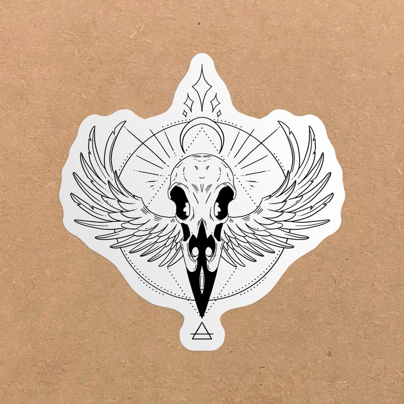 May include: Black and white line art sticker of a bird skull with wings, surrounded by a geometric design. The design includes a crescent moon, stars, and a triangle.