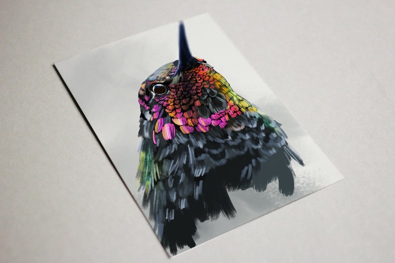 May include: A close-up of a hummingbird with iridescent feathers in shades of pink, green, yellow, and orange. The bird's head is turned to the side, and its eye is visible. The background is a soft, white blur.