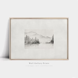 May include: A black and white pencil drawing of a lake and mountains. The drawing is framed in a gold frame. The text "Wall Gallery Prints" and "vintage | art | collection" is below the frame.