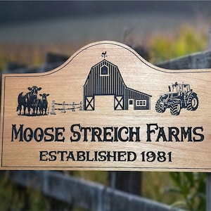 May include: Wooden sign with the text "Moose Streich Farms Established 1981". The sign features illustrations of cows, a barn, and a tractor. The sign is made of light brown wood.
