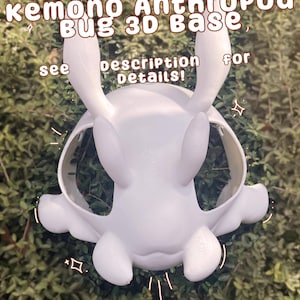 Puede incluir: Base 3D impresa en blanco para un personaje kemono con temática de insectos. La base tiene dos orejas grandes y un cuerpo redondeado. El texto "kemono Anthropod Bug 3D Base" está en la parte superior de la imagen. El texto "ver descripción para más detalles!" está debajo de la base.