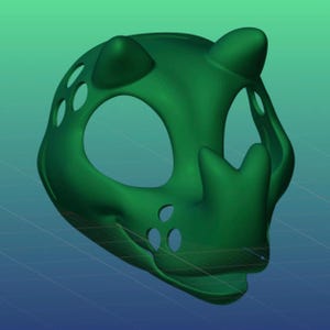 May include: A 3D-printed green mask with large eye openings, small ear-like protrusions, and a smiling mouth. The mask has several small, circular cutouts on the sides and top. The mask is designed to be worn on the face.