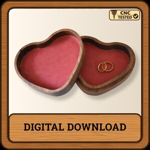 Puede incluir: Una caja de madera en forma de coraz&oacute;n con acabado marr&oacute;n oscuro y forro interior de terciopelo rojo. Dos anillos dorados descansan dentro de la caja. La imagen incluye un icono CNC TESTED y el texto DIGITAL DOWNLOAD en la parte inferior.