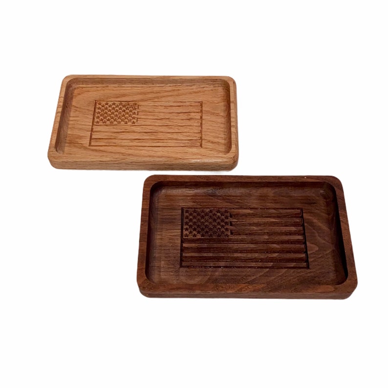 May include: Two wooden trays with an American flag design. The tray on the left is made of light wood and the tray on the right is made of dark wood.