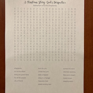 May include: A printed word search puzzle titled "A Christmas Story: God's Perspective." The puzzle includes a grid of letters and a list of related words such as "shepherds," "Christ the Lord," and "heavenly host."