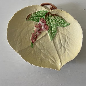 May include: A set of three ceramic mugs with a speckled, matte finish. The mugs are in shades of cream, light brown, and dark brown. Each mug has a simple, minimalist design, perfect for coffee or tea.