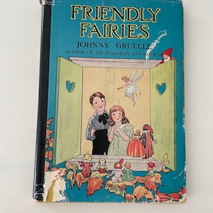 May include: Vintage children's book titled "Friendly Fairies" by Johnny Gruelle. The cover features a teal background with the title in yellow and a colorful illustration of children and fairies. The book shows signs of wear.
