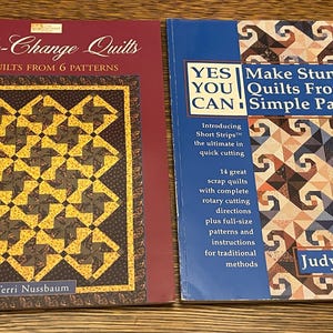 May include: Two quilting books with colorful quilt designs on the covers. The book on the left is titled "Quick-Change Quilts" and the book on the right is titled "YES YOU CAN Make Stunning Quilts From Simple Patterns".