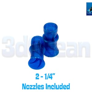 May include: Two blue nozzles, each approximately 2.25 inches in height, are displayed against a white background. The nozzles have a unique, curved design. The text "2 - 1/4" Nozzles Included" is at the bottom.