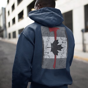 May include: A navy blue hoodie with a distressed Canadian flag design featuring a red axe and a black maple leaf on the back.