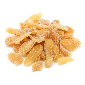 May include: A pile of candied ginger, coated in sugar crystals, on a white background.