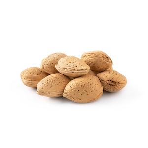May include: A group of almonds, with their shells removed, are arranged in a pile on a white background.