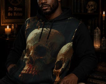 May include: A black hooded sweatshirt featuring a large, detailed graphic print of two human skulls on the front. The skulls are rendered in shades of brown, beige, and dark red, set against a dark background. The hoodie includes black drawstrings.