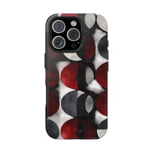 May include: A smartphone case featuring a geometric design of red, black, white, and grey semi-circles. The case has a glossy finish and a black border, designed to fit a smartphone.
