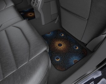 May include: Car floor mats with a dark blue background and a pattern of orange and blue circular designs. The mats are placed in the back seat area of a car, with the seats and interior visible.
