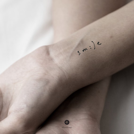 Single needle Smile tattoo on the finger