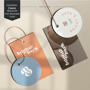 Könnte beinhalten: Ein Branding-Set bestehend aus einem rechteckigen orangefarbenen Anhänger, einem runden blauen Anhänger mit einem weißen B, einem runden weißen Anhänger mit Logo und einer rechteckigen dunkelbraunen Visitenkarte. Alle tragen den Text bright & bark.