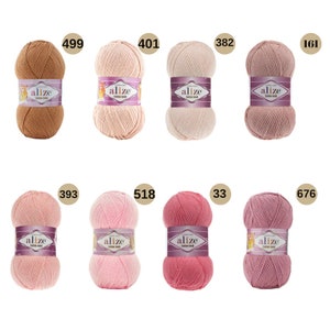 May include: A collection of ten balls of yarn in various shades of pink, peach, and brown. Each ball is labelled "alize" and has a number printed on the label.