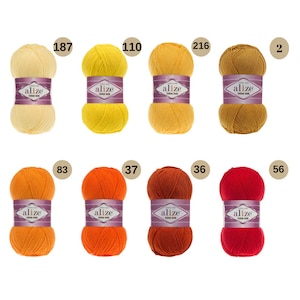 May include: Aliz&eacute; Cotton Gold yarn in ten different colours: cream, yellow, gold, orange, red, and shades in between. Each ball of yarn has a label with the brand name "Aliz&eacute;" and the words "Cotton Gold".