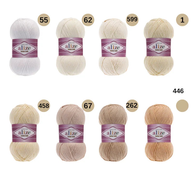 May include: A collection of ten balls of yarn in various shades of white, beige, and brown. The yarn is labelled "alize Cotton Gold" and the balls are numbered 55, 62, 599, 1, 458, 67, 262, 446.