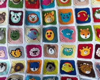 May include: A colorful crocheted blanket with various animal and geometric shapes. The blanket is made of different colored yarn and has a square pattern.