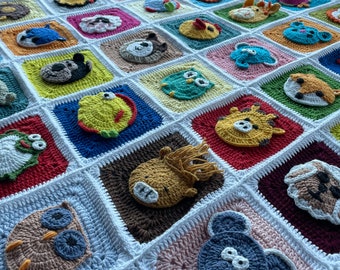 May include: A white crocheted blanket with squares featuring various animal designs. Each square is outlined in white and features a different animal, including an owl, a pig, a fish, and a butterfly. The blanket is made with a soft, textured yarn.