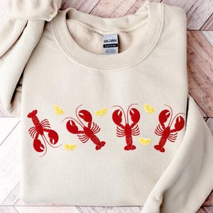 Sudadera con langosta bordada: cuello redondo náutico Coquette