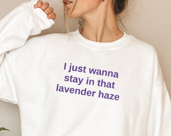 May include: White sweatshirt with the text "I just wanna stay in that lavender haze" printed in purple.