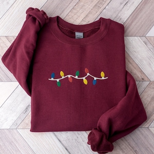 Geborduurd kerstlichtsweater: vakantie ronde hals