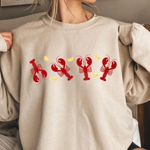 Sudadera con langosta bordada: cuello redondo náutico Coquette