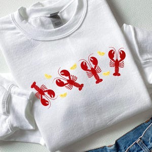 Sudadera con langosta bordada: cuello redondo náutico Coquette