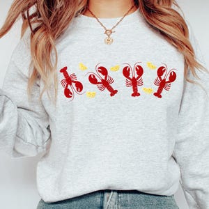 Sudadera con langosta bordada: cuello redondo náutico Coquette