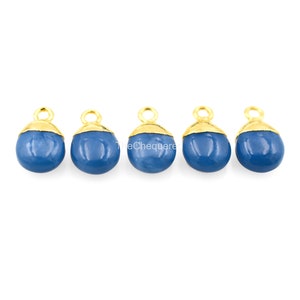 May include: Five gold-plated pendant charms with blue gemstone cabochons. Each charm has a loop for attaching to a necklace or bracelet.