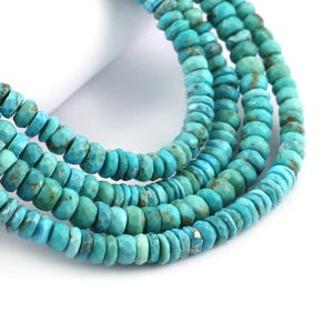 May include: Strands of turquoise gemstone beads. The beads are a mix of light and dark blue-green hues, with a faceted, irregular shape. The beads are strung together, creating a necklace or bracelet.