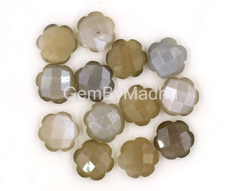 May include: A collection of twelve gray and brown gemstone flower-shaped beads. The beads are faceted and have a shimmery finish.