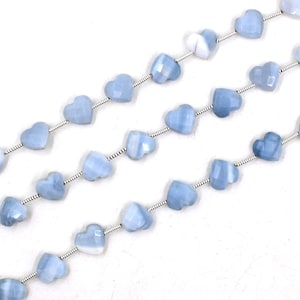 May include: A strand of light blue heart-shaped opal beads strung on silver wire.