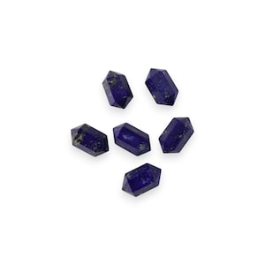 May include: Six polished lapis lazuli double terminated crystal points. The crystals are a deep blue color with flecks of gold, arranged on a white background. Each crystal is approximately 1 inch in length.