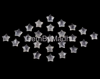 May include: A collection of 20 clear quartz star-shaped cabochons, scattered on a black background. GemByMadhu is printed in the center of the image.