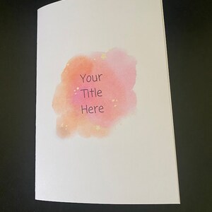 May include: A blank white card with a watercolor design in shades of pink and orange. The design has a speckled effect and the words "Your Title Here" are written in black text.