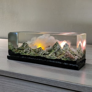 Resin diorama, miniature landscape, sunset mountain, hand-sculpted, romantic sunrise, ornament