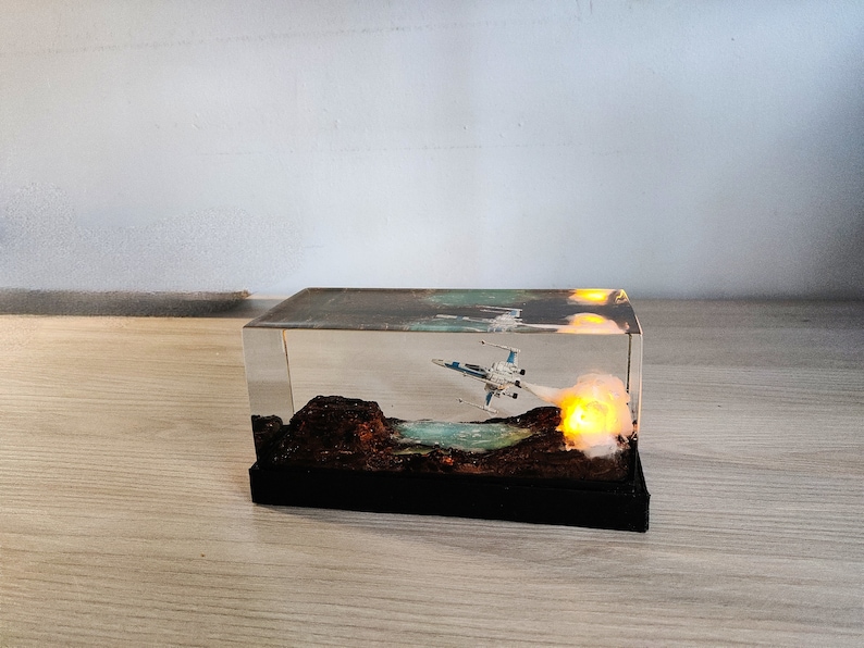 X-Wing Resin Sculpture with LED Launch Sequence: A detailed resin sculpture featuring the X-Wing in launch mode, with LEDs adding a glowing effect that brings the thrill of Star Wars space battles to life.